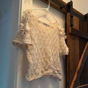 Crochet style crop top with flower appliqué